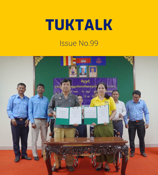 TukTalk issue 99 cover above a photo of officials and TukTuk staff holding signed agreement folders at a table