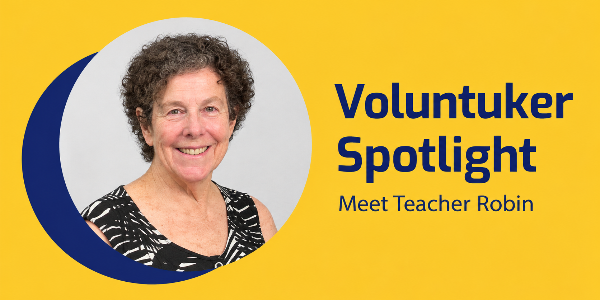 Voluntuker Spotlight banner with a smiling portrait of Teacher Robin, a curly-haired woman, and text Meet Teacher Robin